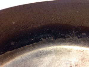Scortched fat at the edge of pan