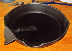 A cracked cast iron pan